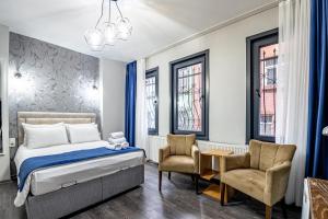 a bedroom with a bed and two chairs at Sultan Mansion in Istanbul