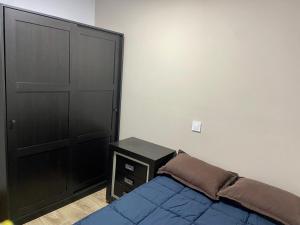 a bedroom with a bed and a black door at La Joya in Navalacruz