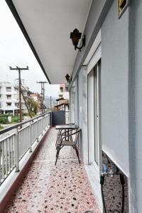 a balcony with a table and benches on it at Friendly Flat 1 in Edessa