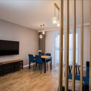 une salle à manger avec une table et des chaises bleues dans l'établissement Apartament na wynajem 32 m2, à Bochnia