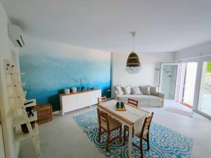 a living room with a table and a couch at Le Sfumature del Mare in San Vito Chietino