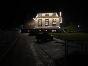 a white building with lights on it at night at Villa Mramor in Brzeće