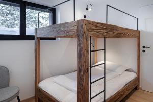 a room with two bunk beds and a window at LUXE VISTA Mountain Chalet Cermis - direkt an der Skipiste und Alm in Cavalese