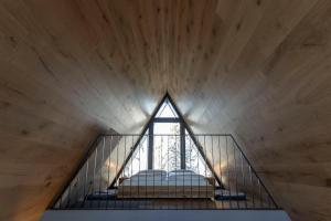 a room with a window on the top of a stairs at LUXE VISTA Mountain Chalet Cermis - direkt an der Skipiste und Alm in Cavalese