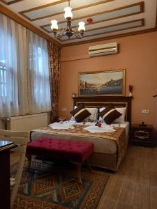 a bedroom with a large bed with a red bench at Emirhan Hotel & Sultanahmet in Istanbul