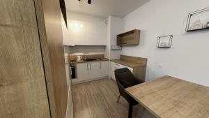 a small kitchen with a table and a dining room at 1 room Apartment with terrace, Petržalka in Bratislava