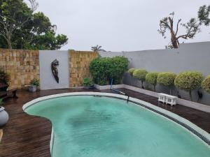 a swimming pool in the middle of a yard at Bunitrix Guesthouse in Summerstrand