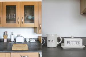 a kitchen counter with two coffee mugs and a toaster at Railway Cottage, Port Sunlight in Bebington