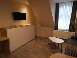 TV a/nebo společenská místnost v ubytování Apartment Hotel Rüther