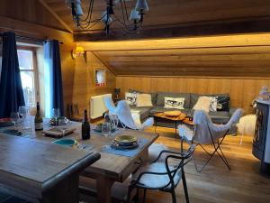 a living room with a table and a couch at l’escalade 3 in Courchevel