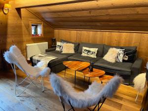 a living room with a couch and some white feathers at l’escalade 3 in Courchevel