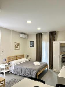 a bedroom with a large bed and a room with a table at B&B Toci in Volla