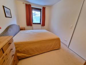 a small bedroom with a bed and a window at Apartments Juri & Hermann 1 in Bad Kleinkirchheim