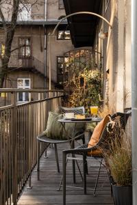 a patio with a table and chairs on a balcony at Moja apartments in Kraków
