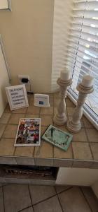 a table with two vases and a magazine on it at 25 Sunset View in Langstrand