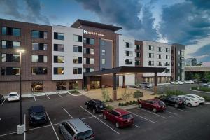 a rendering of a hotel with cars parked in a parking lot at Hyatt House Columbus OSU Short North in Columbus