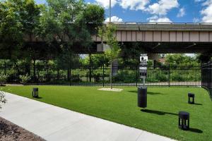 a grassy area with a street sign and a bridge at Hyatt House Columbus OSU Short North in Columbus