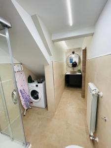 uma casa de banho com uma máquina de lavar roupa e um lavatório em Appartamento Totò em San Salvo