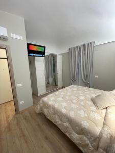 a bedroom with a bed and a tv on the wall at Appartamento Totò in San Salvo