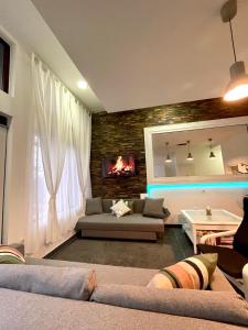 a living room with a couch and a fireplace at Pepino, Holiday House with a garden in Vrhnika