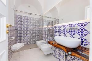 a bathroom with a sink and a toilet in it at La Bizantina Luxury Villa in Positano