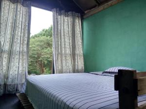 Tempat tidur dalam kamar di Castelinho