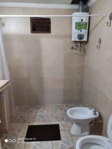 a bathroom with a toilet and a sink at Parana Inn in Puerto Iguazú