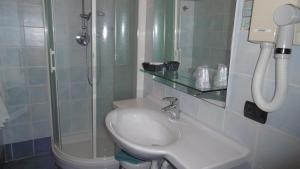 a bathroom with a shower and a toilet and a sink at Hotel Riviera in Arenzano