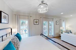 a bedroom with a bed and a living room at Village of South Walton EB210 in Rosemary Beach