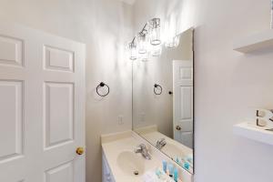 a white bathroom with a sink and a mirror at Village of South Walton EB210 in Rosemary Beach