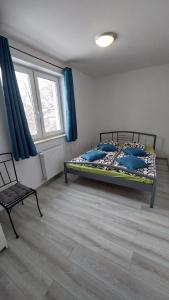 a bedroom with a bed and a chair in a room at SUNNY HILL , KOWARY in Kowary