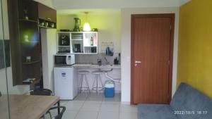 a small kitchen with a sink and a counter at Flat Quartier - Aldeia das Águas in Barra do Piraí
