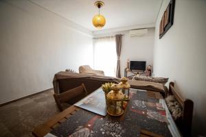 a living room with a table and a couch at Trikala center 5 in Tríkala