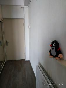 a stuffed penguin sitting on a shelf in a room at Apartment Sandra in Tbilisi City