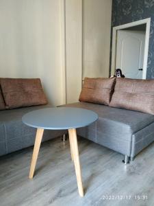 a living room with a table and a couch at Apartment Sandra in Tbilisi City
