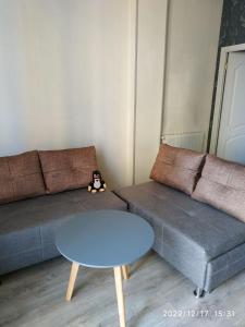 a living room with a couch and a table at Apartment Sandra in Tbilisi City