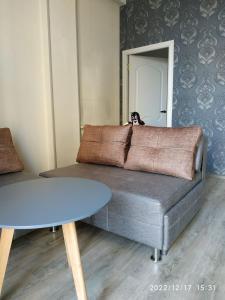 a living room with a couch and a table at Apartment Sandra in Tbilisi City