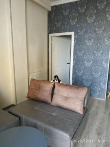 a dog is sitting on a bed in a room at Apartment Sandra in Tbilisi City