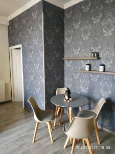 a dining room with two chairs and a table at Apartment Sandra in Tbilisi City