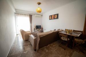 a living room with a couch and a table at Trikala center 5 in Tríkala