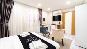a hotel room with a bed and a desk at Best Hotel Pendik in Istanbul