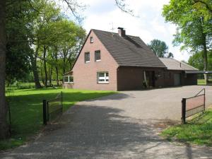 a house with a driveway in front of it at Haus Eichengrund in Papenburg