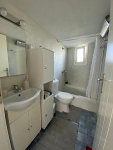 a bathroom with a sink and a toilet and a shower at Molos Sea View House - Paros Greece in Molos Parou
