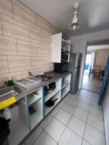 a kitchen with a sink and a stove top oven at 3D 2B cerca playa y centro, Park Surf in Iquique
