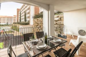 a dining room with a table and chairs on a balcony at 2187-Lovely 2bedrooms with pool and playground in Manilva