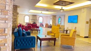 a living room with colorful chairs and tables at Navarria Blue Hotel in Limassol