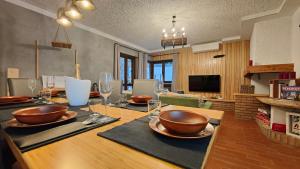 a dining table with bowls and wine glasses on it at Chalet Bornhome CIR O17022 in Borno