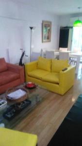 sala de estar con sofá amarillo y mesa en Depto en Belgrano a 5 min de River 1 subte, cerca de lo mejor de Bs As en Buenos Aires