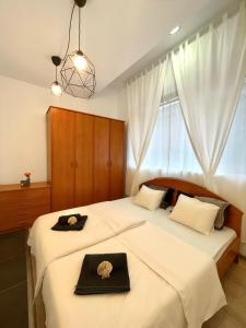 a bedroom with two beds with hats on them at Pepino, Holiday House with a garden in Vrhnika