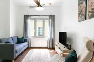 un salon avec un canapé et une télévision dans l'établissement Old Town House, à Peniche